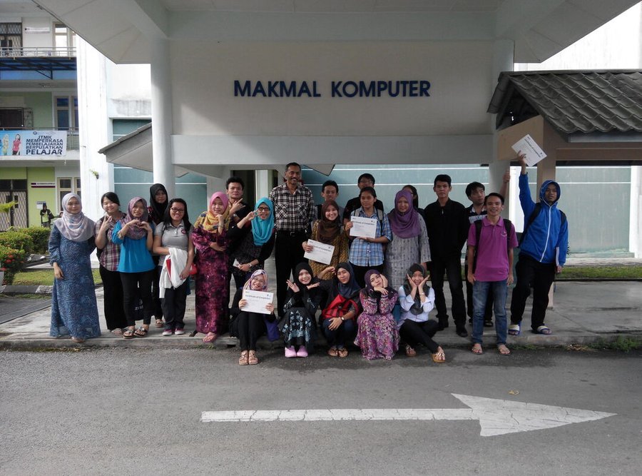 Participants posing with certificates outside a computer lab after an Avimur Solutions training session